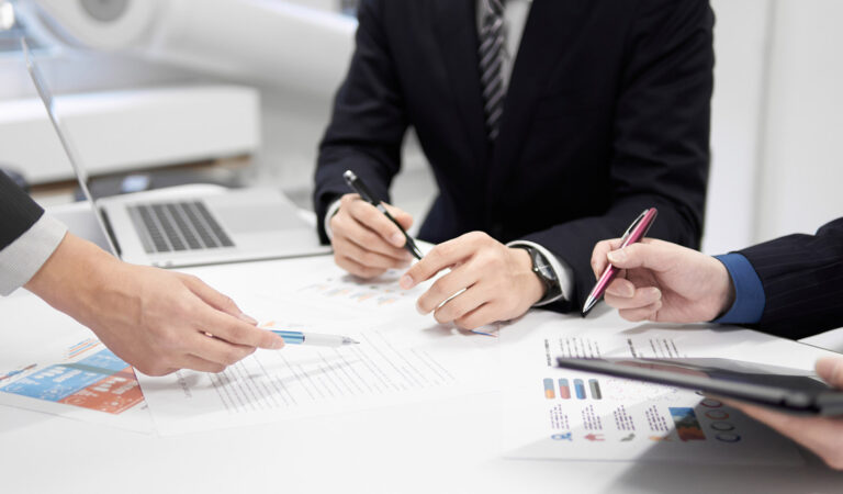 Insurance carriers reviewing documents on a table.