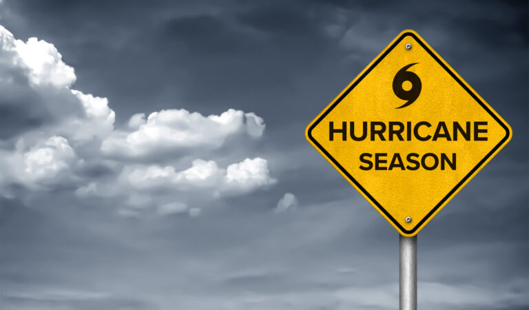 Hurricane season sign with dark clouds in the background for national hurricane awareness week.