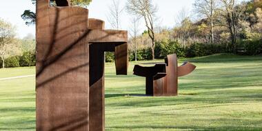 Rusted metal sculptures in a green space