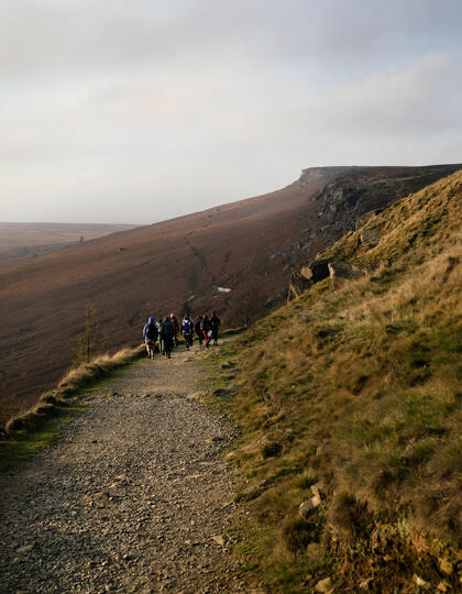 Hikers heading down a path on an inclusive adventure trip