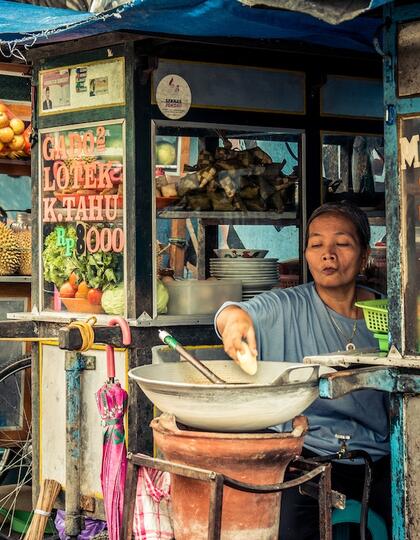 A market trader at a snack stall in Bali, Indonesia