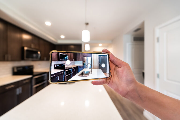 A person protecting their assets by taking a photo of their home inventory.