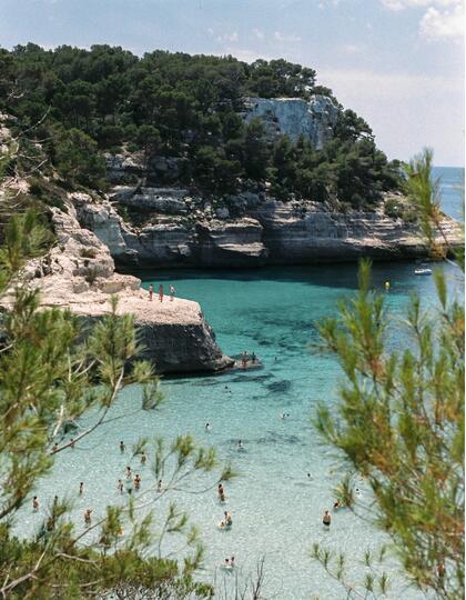 People enjoying the sun on the Menorcan coastline