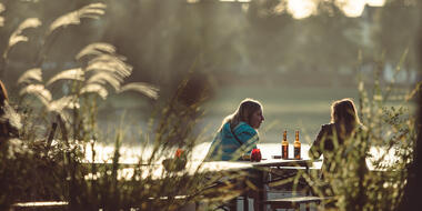 Two woman drinking beers