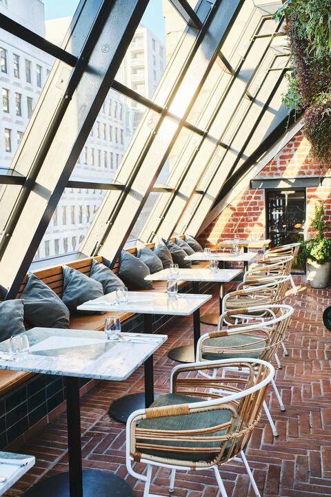 Tables beneath a slanting glass roof