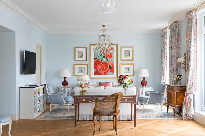 A powder blue living space in a suite at Hotel Le Bristol