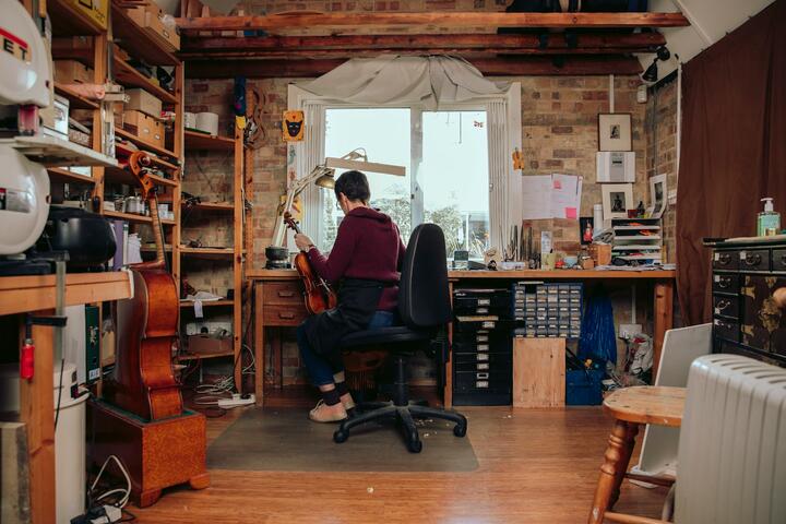 A woman sits in a workshop