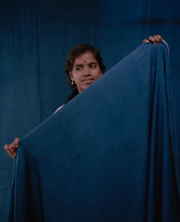 A member of staff with cloth at The Colours of Nature, Tamil Nadu, India