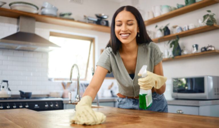 A person tackling their spring cleaning and home safety checklist.